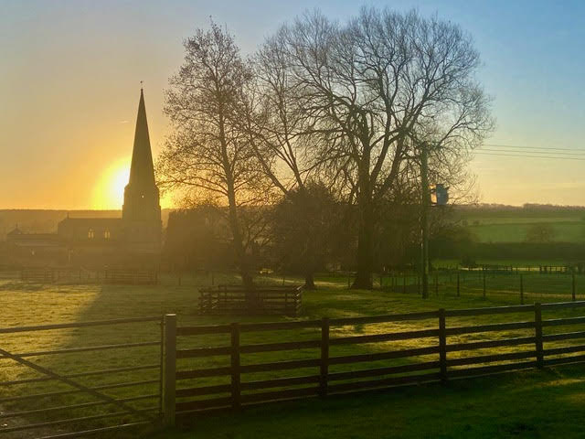 Image of a sunset over a church in Barrowden